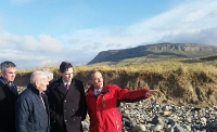 EROSION: Minister Simon Harris (second from right) and party colleagues are shown the damage caused by erosion at Rosses Point beach by Gary Salter, senior engineer at Sligo County Council