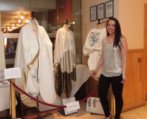 DESIGN: St Angela's student Emma Curtis stands next to her design work on display at the Yeats Nobel Dinner in June of this year at the Radisson Blu Hotel in Sligo.